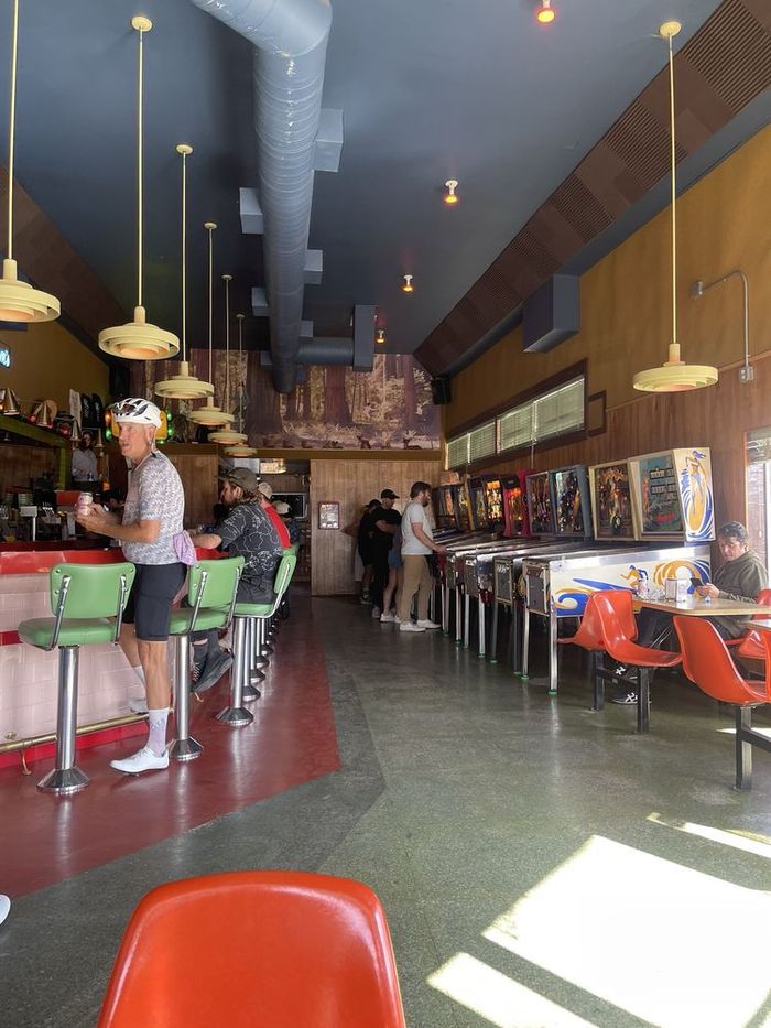 Sunlight across our red floor and counter stools