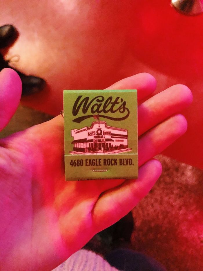 A green Walt's matchbook with a drawing of the building and the address 4680 Eagle Rock Blvd